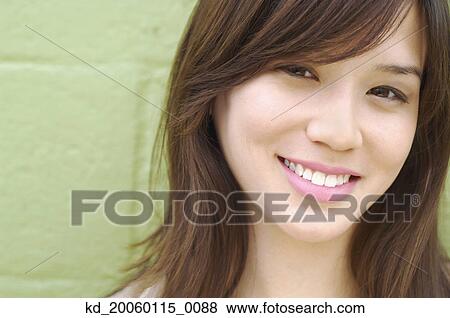 Stock Photo - Young woman smiling for the camera. Fotosearch