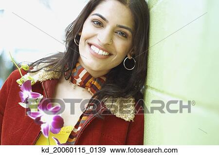 Young woman smiling for the camera View Large Photo Image Stock Photo - Young woman smiling for the camera. Fotosearch
