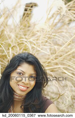 Young woman smiling for the camera View Large Photo Image Stock Photo - Young woman smiling for the camera. Fotosearch
