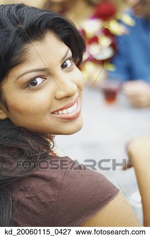 Stock Photo - Young woman smiling for the camera. Fotosearch