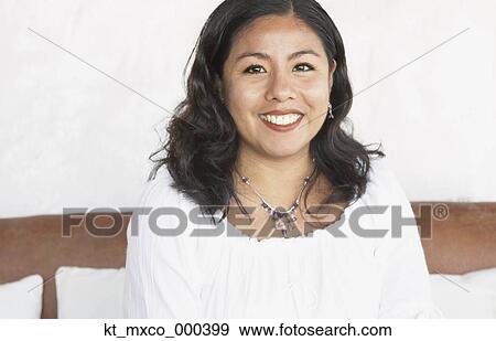 Young woman smiling for the camera View Large Photo Image Stock Photo - Young woman smiling for the camera. Fotosearch