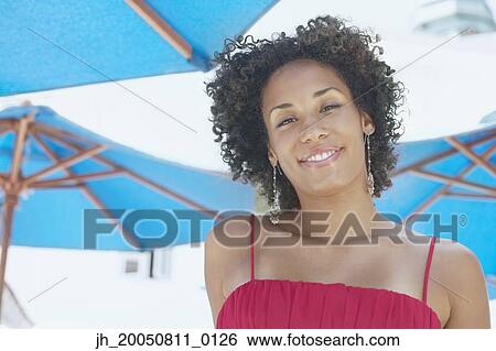 Young woman smiling for the camera View Large Photo Image Stock Photograph - Young woman smiling for the camera. Fotosearch