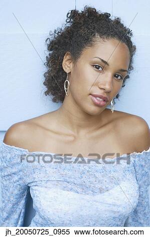 Young woman smiling for the camera View Large Photo Image Stock Photography - Young woman smiling for the camera. Fotosearch