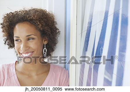Stock Photography - Young woman smiling for the camera. Fotosearch