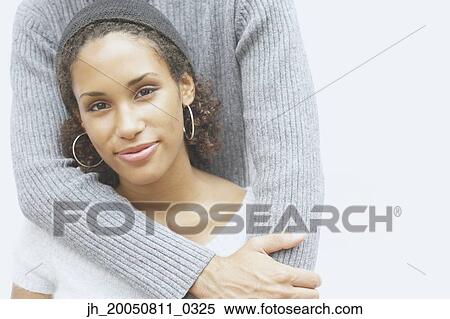 Young woman smiling for the camera with boyfriend View Large Photo Image Stock Photography - Young woman smiling for the camera with boyfriend. Fotosearch