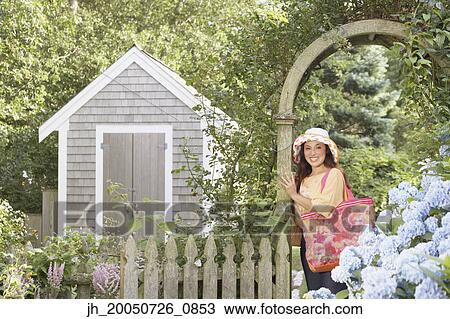 Young woman standing in archway View Large Photo Image Stock Image - Young woman standing in archway. Fotosearch