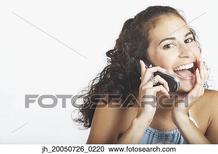 Young woman talking on her cell phone View Large Photo Image Stock Image - Young woman talking on her cell phone. Fotosearch