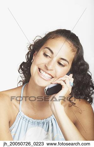 Stock Image - Young woman talking on her cell phone. Fotosearch