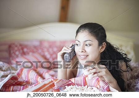 Young woman talking on the phone View Large Photo Image Stock Photo - Young woman talking on the phone. Fotosearch