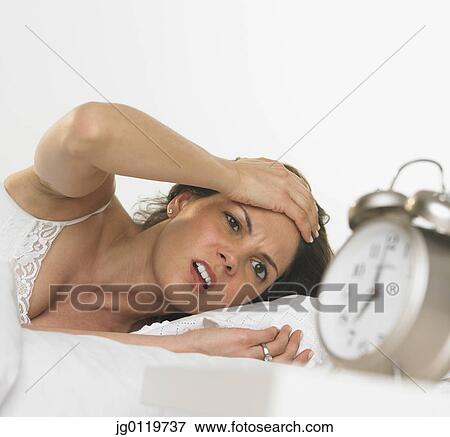 Young woman waking up View Large Photo Image Stock Photo - Young woman waking up. Fotosearch