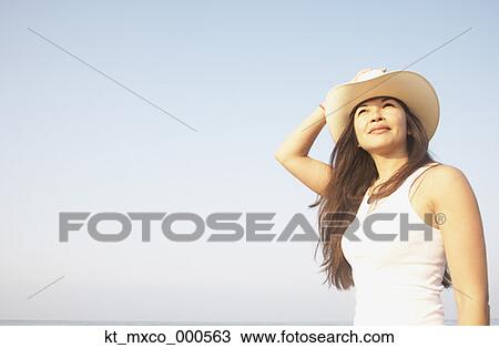 Young woman wearing a cowboy hat View Large Photo Image Stock Image - Young woman wearing a cowboy hat. Fotosearch