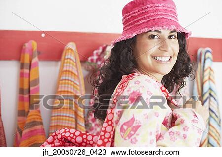 Young woman wearing a hat and shoulder bag smiling for the camera View Large Photo Image Stock Image - Young woman wearing a hat and shoulder bag smiling for the camera. Fotosearch