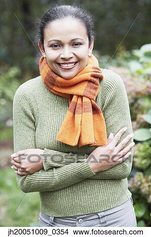 Young woman wearing a scarf outdoors View Large Photo Image Picture - Young woman wearing a scarf outdoors. Fotosearch