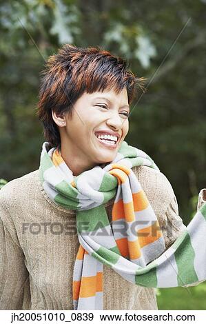Young woman wearing two scarves outdoors View Large Photo Image Stock Photo - Young woman wearing two scarves outdoors. Fotosearch