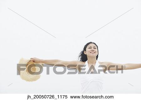 Young woman with her arms outstretched View Large Photo Image Stock Photography - Young woman with her arms outstretched. Fotosearch