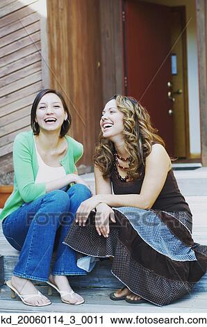 Young women laughing together View Large Photo Image Stock Image - Young women laughing together. Fotosearch