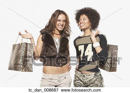 Stock Photo - Young women shopping together. Fotosearch