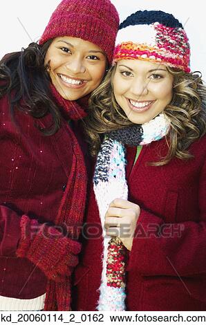 Stock Image - Young women smiling for the camera. Fotosearch