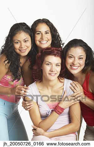 Young women smiling for the camera View Large Photo Image Stock Photograph - Young women smiling for the camera. Fotosearch