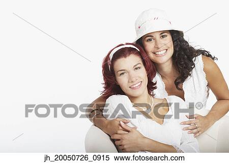 Young women smiling for the camera together View Large Photo Image Stock Photography - Young women smiling for the camera together. Fotosearch