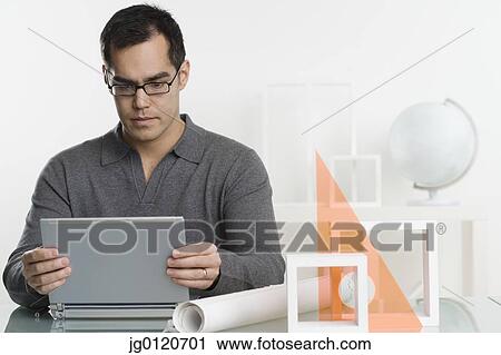 Stock Image - Businessman using his laptop. Fotosearch