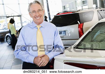 Stock Image - Car salesman smiling. Fotosearch