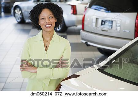 Stock Image - Car saleswoman smiling. Fotosearch