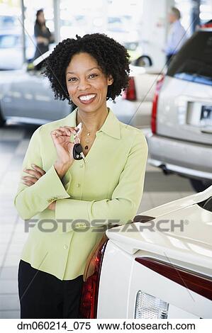 Stock Photography - Car saleswoman smiling. Fotosearch