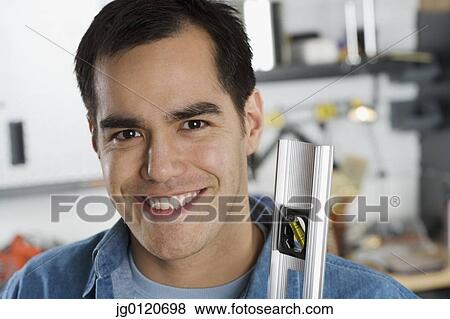 Stock Photo - Carpenter holding a ruler. Fotosearch