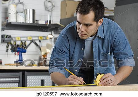 Carpenter making marks on wood View Large Photo Image Stock Photo - Carpenter making marks on wood. Fotosearch