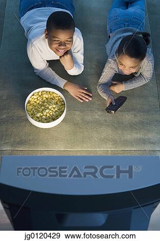 Children watching television View Large Photo Image Stock Photo - Children watching television. Fotosearch