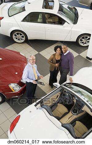 Couple buying a car View Large Photo Image Stock Photo - Couple buying a car. Fotosearch