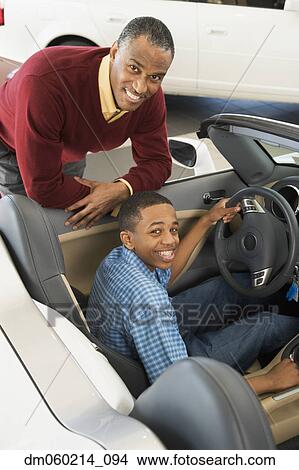 Father and son at a car dealership View Large Photo Image Picture - Father and son at a car dealership. Fotosearch
