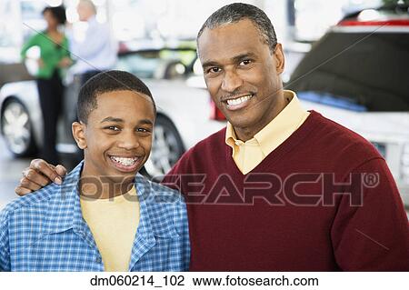 Father and son at a car dealership View Large Photo Image Stock Image - Father and son at a car dealership. Fotosearch