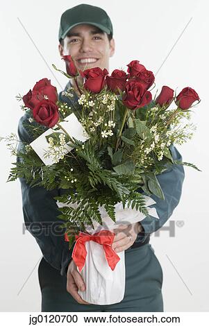 Stock Image - Mailman carrying a bunch of roses. Fotosearch
