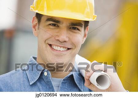 Manual worker holding blueprints View Large Photo Image Picture - Manual worker holding blueprints. Fotosearch