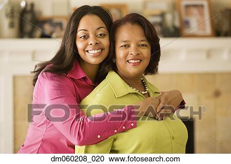 Stock Image - Mother and daughter smiling together. Fotosearch