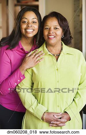 Stock Photo - Mother and daughter smiling together. Fotosearch