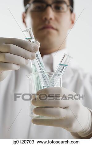 Scientist examining chemicals in test tubes View Large Photo Image Stock Image - Scientist examining chemicals in test tubes. Fotosearch