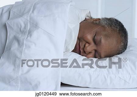Senior woman asleep in bed View Large Photo Image Stock Photo - Senior woman asleep in bed. Fotosearch