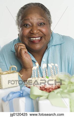 Stock Photography - Senior woman celebrating her birthday. Fotosearch