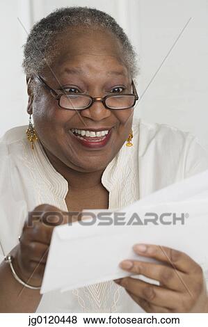 Stock Photo - Senior woman checking her mail. Fotosearch