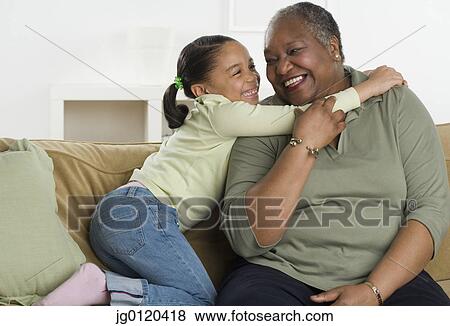 Stock Photo - Senior woman hugging her granddaughter. Fotosearch