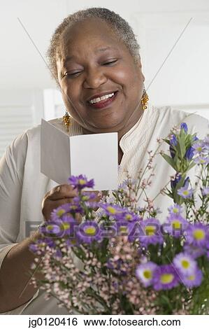 Stock Photograph - Senior woman reading a card. Fotosearch
