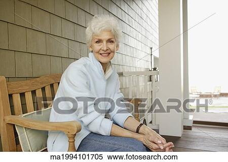 Senior woman smiling on the porch View Large Photo Image Stock Photography - Senior woman smiling on the porch. Fotosearch