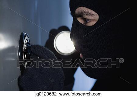 Thief unlocking a combination lock View Large Photo Image Stock Image - Thief unlocking a combination lock. Fotosearch