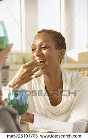 Stock Photography - Woman eating. Fotosearch