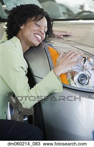 Woman hugging her car View Large Photo Image Stock Image - Woman hugging her car. Fotosearch