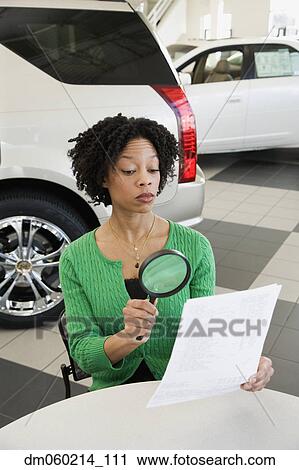 Woman reading the fine print with a magnifying glass View Large Photo Image Stock Image - Woman reading the fine print with a magnifying glass. Fotosearch