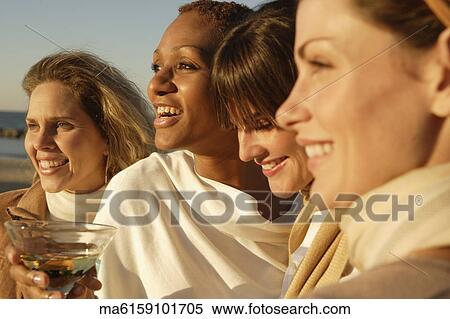 Stock Photography - Women on the beach together. Fotosearch